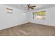 Large bedroom with neutral carpet, ceiling fan, and two windows with wooden blinds for natural light at 4624 W Heyerdahl Ct, New River, AZ 85087