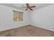 Bedroom featuring carpet, ceiling fan, and a large window at 4624 W Heyerdahl Ct, New River, AZ 85087