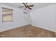 Bedroom features carpet, ceiling fan, two windows and a closet at 4624 W Heyerdahl Ct, New River, AZ 85087