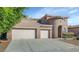 Exterior featuring a three-car garage and a unique turret-style entrance with a neutral color palette at 4624 W Heyerdahl Ct, New River, AZ 85087