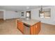 Bright eat-in kitchen featuring wooden cabinets, stone countertops, stainless steel appliances, and a peninsula at 4624 W Heyerdahl Ct, New River, AZ 85087