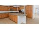 Eat-in kitchen with wood cabinets, stone countertops, stainless appliances, and island with a sink and a raised breakfast bar at 4624 W Heyerdahl Ct, New River, AZ 85087