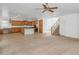 Open living room with tile flooring, carpet, a staircase, and an island that separates the kitchen from the living space at 4624 W Heyerdahl Ct, New River, AZ 85087