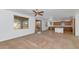 Bright and airy living room with an island connecting the space to an adjacent kitchen area at 4624 W Heyerdahl Ct, New River, AZ 85087