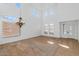 Bright, spacious living room with high ceilings, a chandelier, and large windows, and neutral-colored walls at 4624 W Heyerdahl Ct, New River, AZ 85087
