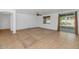 Bright living room with tile entry and neutral carpet, ceiling fan, window with wooden blinds, and sliding glass doors to the back yard at 4624 W Heyerdahl Ct, New River, AZ 85087
