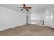 Spacious living room features neutral carpet, ceiling fan, and large arched entryway at 4624 W Heyerdahl Ct, New River, AZ 85087