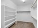 Walk-in closet with carpeting, shelving, and hanging rods for optimal organization at 4624 W Heyerdahl Ct, New River, AZ 85087