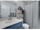 Bathroom featuring a blue vanity with a clean countertop and shower/tub combination at 5213 S Monaco Dr, Tempe, AZ 85283