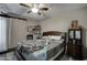 Bedroom with ceiling fan, sliding glass door, and wood-look laminate flooring at 5213 S Monaco Dr, Tempe, AZ 85283