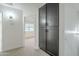 Hallway with carpet and large storage cabinet leads to bedroom with ceiling fan at 5246 E Enrose St, Mesa, AZ 85205