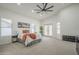 Spacious main bedroom with natural light, a ceiling fan, and an ensuite bathroom at 5246 E Enrose St, Mesa, AZ 85205