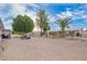 Expansive backyard features desert landscaping, mature trees and convenient seating areas at 5725 E Colby St, Mesa, AZ 85205