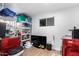 A crowded basement with a window, a television, and a red washing machine and dryer at 5725 E Colby St, Mesa, AZ 85205