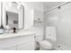 Modern bathroom with a glass shower, white cabinets, and marble countertops at 5725 E Colby St, Mesa, AZ 85205