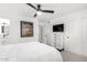 Bright bedroom featuring a ceiling fan, carpet, and a bathroom connected to the bedroom at 5725 E Colby St, Mesa, AZ 85205