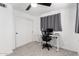 Cozy bedroom with a home office setup, gray carpet, and a ceiling fan at 5725 E Colby St, Mesa, AZ 85205