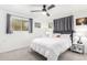 Bright bedroom with a ceiling fan, plush carpeting, and light gray curtains at 5725 E Colby St, Mesa, AZ 85205