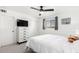 A bright bedroom with a white dresser, TV, ceiling fan and a window at 5725 E Colby St, Mesa, AZ 85205