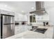 Contemporary kitchen boasts stainless steel appliances, quartz countertops, and white cabinetry at 5725 E Colby St, Mesa, AZ 85205