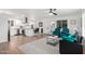 Bright open-concept space featuring hardwood floors, a marble coffee table, and an open kitchen concept at 5725 E Colby St, Mesa, AZ 85205