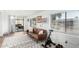 A sunlit living room featuring a black and white carpet, windows, and an exercise bike at 5725 E Colby St, Mesa, AZ 85205