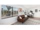Sunlit living room featuring large windows, modern furniture, and an office desk at 5725 E Colby St, Mesa, AZ 85205