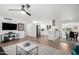 Open-concept living space with hardwood floors, white walls, recessed lighting, and modern furniture at 5725 E Colby St, Mesa, AZ 85205
