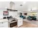 Modern open-concept living space features hardwood floors, a range hood, and an open kitchen concept at 5725 E Colby St, Mesa, AZ 85205