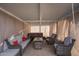 Relaxing covered patio complete with comfortable seating, a hot tub, and cozy curtains at 5725 E Colby St, Mesa, AZ 85205