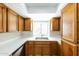 Cozy kitchen features wood cabinets, white counters, and a stainless steel sink at 602 W Grandview Rd, Phoenix, AZ 85023