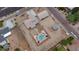 Aerial view of a property featuring a pool, detached garage, and ample yard space at 6020 E Shea Blvd, Scottsdale, AZ 85254