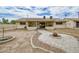 Spacious backyard with a stone pathway leading to a covered patio at 6020 E Shea Blvd, Scottsdale, AZ 85254