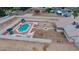 Aerial view of backyard featuring a fenced pool with lounge chairs and a decorative patio area at 6020 E Shea Blvd, Scottsdale, AZ 85254