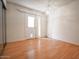 Bright bedroom showcasing wood floors, sliding glass doors, and a ceiling light fixture at 6020 E Shea Blvd, Scottsdale, AZ 85254