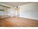 Bright bedroom with wood floors, closet with mirrored sliding doors, and neutral walls at 6020 E Shea Blvd, Scottsdale, AZ 85254