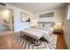 Neutral bedroom showcasing a king-size bed with side tables, soft lighting, and a decorative chevron rug at 6020 E Shea Blvd, Scottsdale, AZ 85254