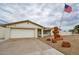 Charming single-story home with an American flag and stacked rocks in the front yard at 6020 E Shea Blvd, Scottsdale, AZ 85254
