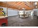 Large garage with a workbench and ample space for storage or projects, featuring a roll-up door at 6020 E Shea Blvd, Scottsdale, AZ 85254