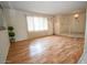 Open living room with hardwood floors, neutral walls, and a view of the entryway at 6020 E Shea Blvd, Scottsdale, AZ 85254