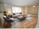Bright living room with a sofa, accent chair, stylish rug, and abundant natural light from a large window at 6020 E Shea Blvd, Scottsdale, AZ 85254