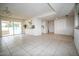 Spacious living space with tile flooring, modern lighting, and an adjacent kitchen area at 6020 E Shea Blvd, Scottsdale, AZ 85254