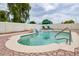 Inviting pool with waterfall feature, surrounded by stone pavers and lounge chairs at 6020 E Shea Blvd, Scottsdale, AZ 85254