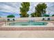 Inviting pool with a waterfall feature and ample seating for relaxation at 6020 E Shea Blvd, Scottsdale, AZ 85254