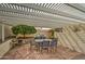 Covered back patio with a dining table set, barbecue grill and a tree at 6614 E Portia St, Mesa, AZ 85215