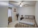 Cozy bedroom with neutral tones, ceiling fan, decorative vases, and a comfortable bed at 6614 E Portia St, Mesa, AZ 85215