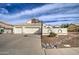 Charming home featuring a two-car garage, basketball hoop and desert landscaping at 6614 E Portia St, Mesa, AZ 85215