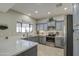 Updated kitchen with stainless appliances, tile backsplash, white countertops and ample cabinet space at 6614 E Portia St, Mesa, AZ 85215