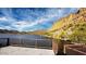 Picturesque lake scene with pier, tranquil waters, and stunning mountain backdrop at 6614 E Portia St, Mesa, AZ 85215