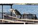 Close up of a bird standing on a lakeside pier, with a view of mountains in the background at 6614 E Portia St, Mesa, AZ 85215